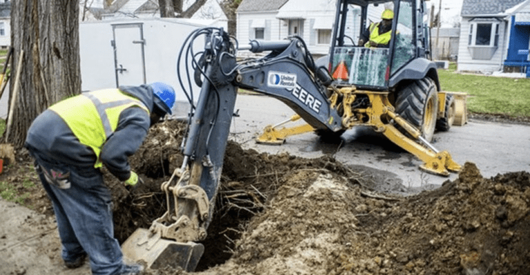 Crews work to dig out and replace lead service lines in April 2018 in Flint, Mich. This spring, a decade after the Flint water crisis began, a federal court held the city in contempt for violating a court order requiring it to reach certain milestones in its lead pipe replacement program. (Jake May/Mlive.com/TNS)